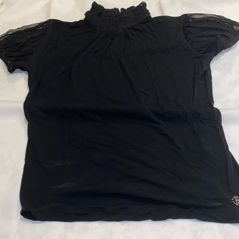 Black turtle neck: Roberto Cavalii